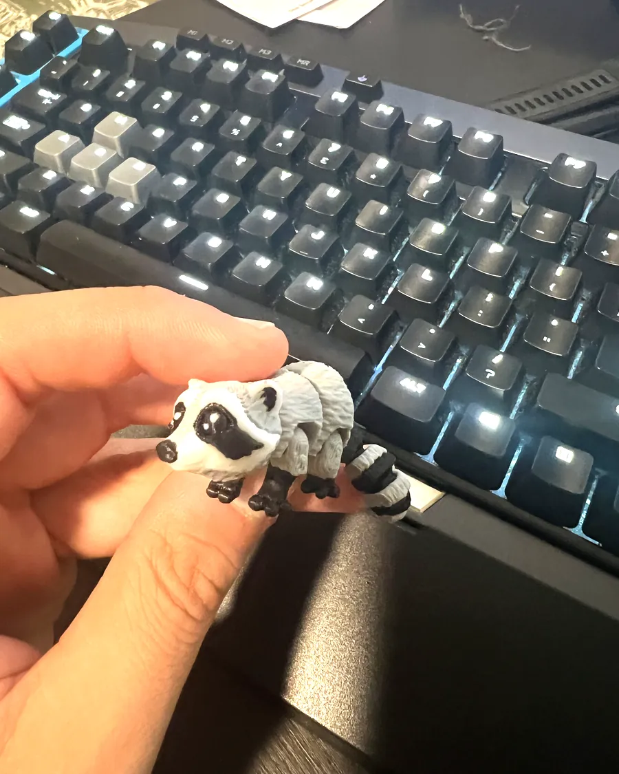 The real Oodle toy held in a child's hand